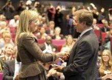 H.M. Queen Máxima of the Netherlands accepts the new volume of the MicroInsurance Compendium from Mr. Craig Churchill of the MicroInsurance Facility at ILO. (2012 Research Conference on Microinsurance. Enschede, the Netherlands. April 2012.)