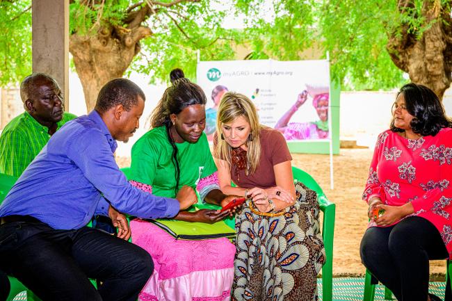 UNSGSA Queen Máxima listens to a myAgro Village Entrepreneur, Mame Diarra (left), and myAgro’s Senegal Interim Country Director, Thierno Faye (far left), to learn how myAgro’s innovative, mobile layaway financing model helps smallholders increase yields and achieve greater financial security. Anushka Ratnayake, founder and CEO of MyAgro, is pictured far right. Photo credit: Patrick van Katwijk
